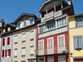 French colourful facades of different shapes with elegant windows and decorative details